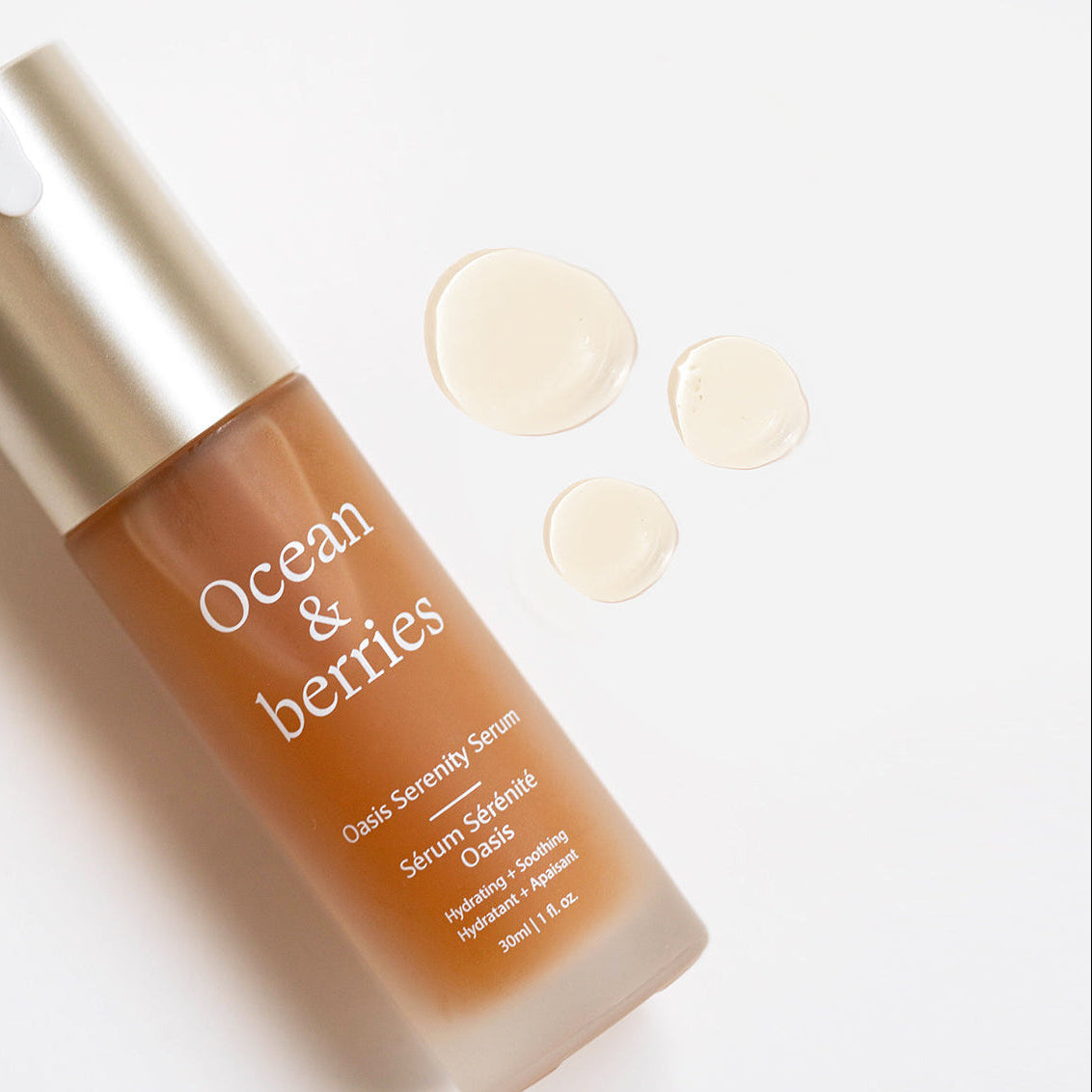 Skincare serum bottle and droplets on white background