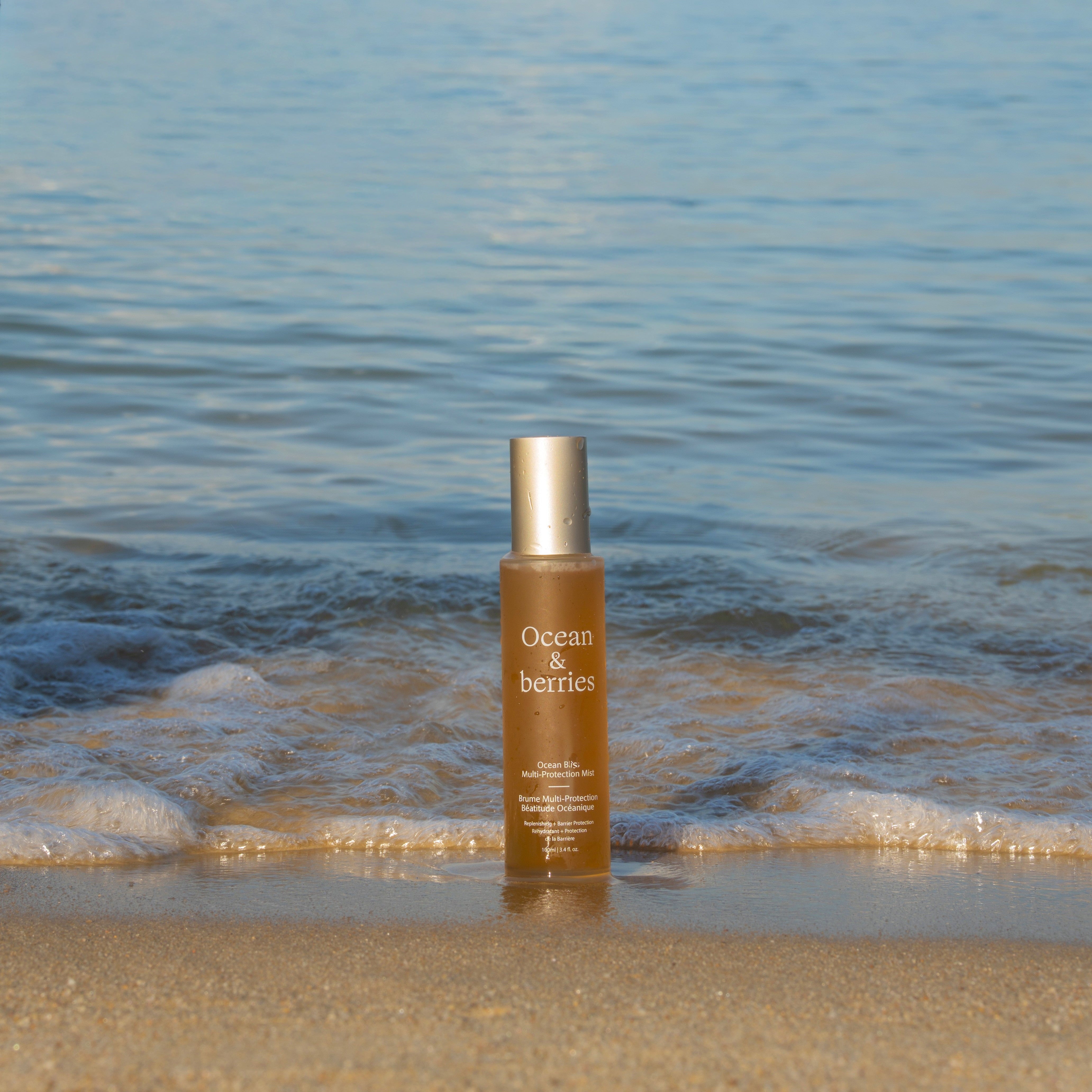 Skincare bottle on a beach with ocean and ships in the background